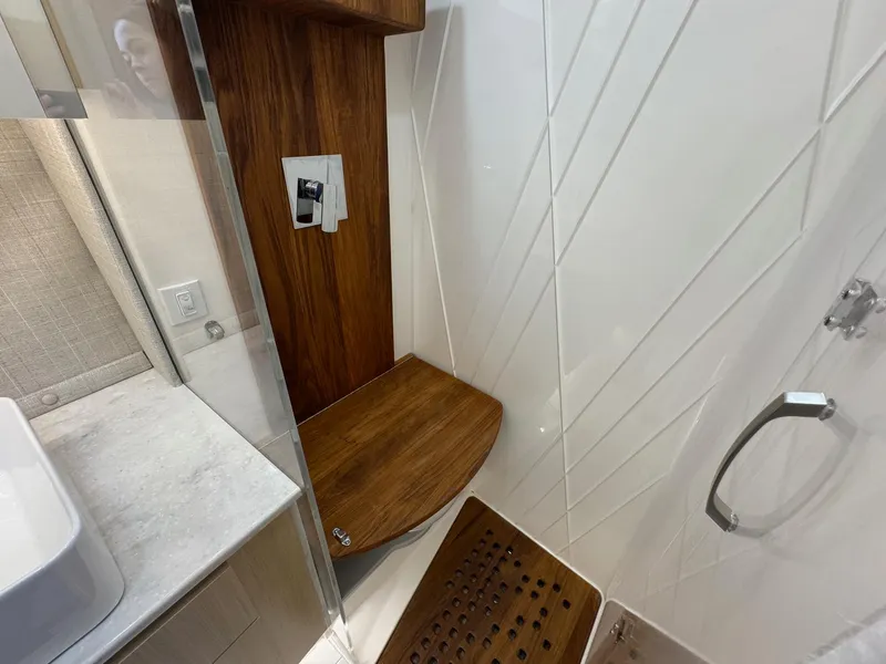 Slide: The Image of Luxurious shower area in 2026 Regal 36 XO yacht with wooden seat and modern fixtures. - 82