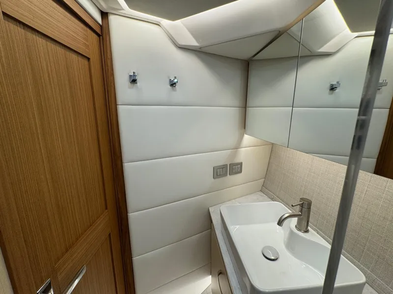 Slide: The Image of Modern bathroom interior in 2026 Regal 36 XO yacht, featuring sleek sink and wooden accents. - 86