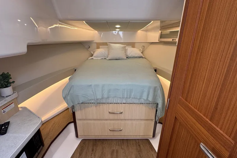 Slide: The Image of Luxurious cabin interior of 2026 Regal 36 XO yacht with cozy bed and wooden accents. - 87