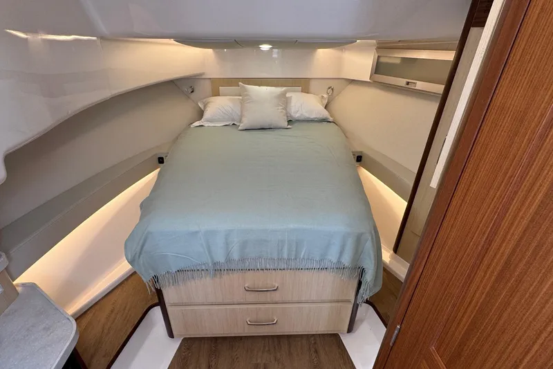 Slide: The Image of 2026 Regal 36 XO yacht interior cabin with bed and wooden accents. - 88