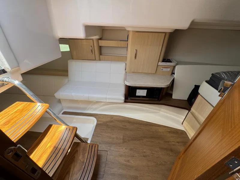 Slide: The Image of Interior of 2026 Regal 36 XO yacht with wooden stairs and modern seating area. - 91