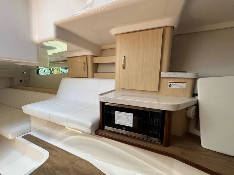 Slide: The Image of Interior of 2026 Regal 36 XO yacht with modern seating and kitchenette. - 92