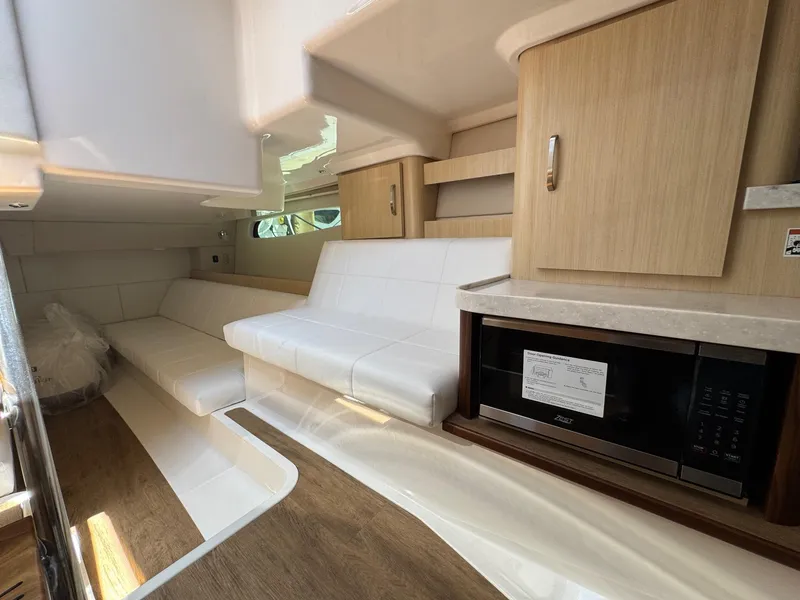 Slide: The Image of Interior of 2026 Regal 36 XO yacht with modern seating and cabinetry. - 93