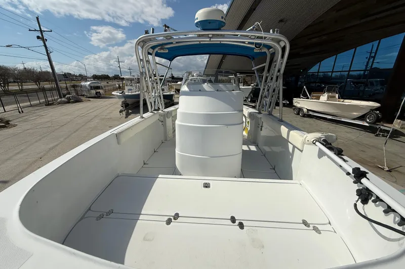 Slide: The Image of 2004 Glacier Bay 260 Canyon Runner boat, spacious deck, under clear sky. - 10