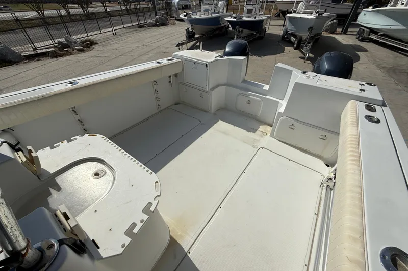 Slide: The Image of 2004 Glacier Bay 260 Canyon Runner boat interior with spacious deck and storage compartments. - 12