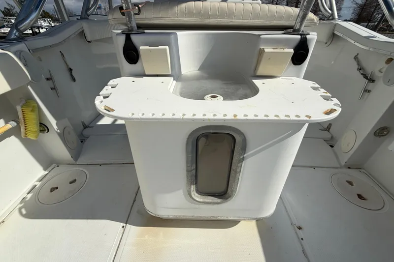 Slide: The Image of 2004 Glacier Bay 260 Canyon Runner boat interior with seating and storage compartments. - 13