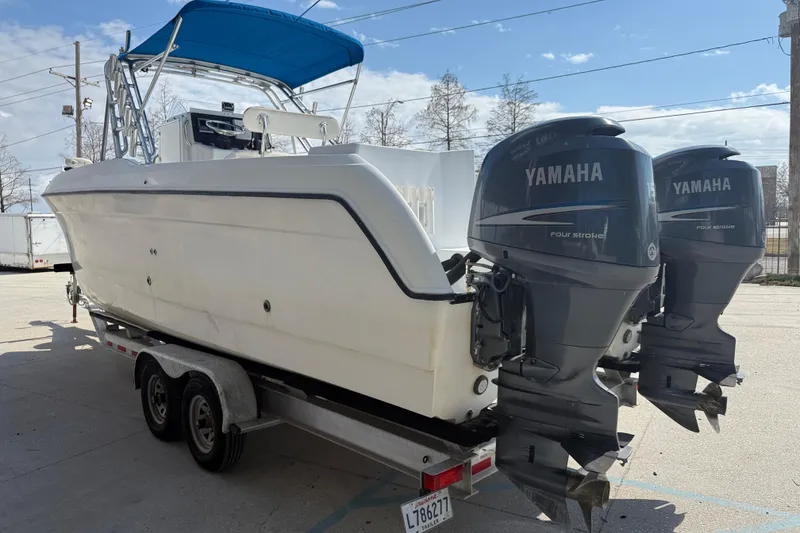 Slide: The Image of 2004 Glacier Bay 260 Canyon Runner boat with twin Yamaha outboard engines on a trailer. - 4