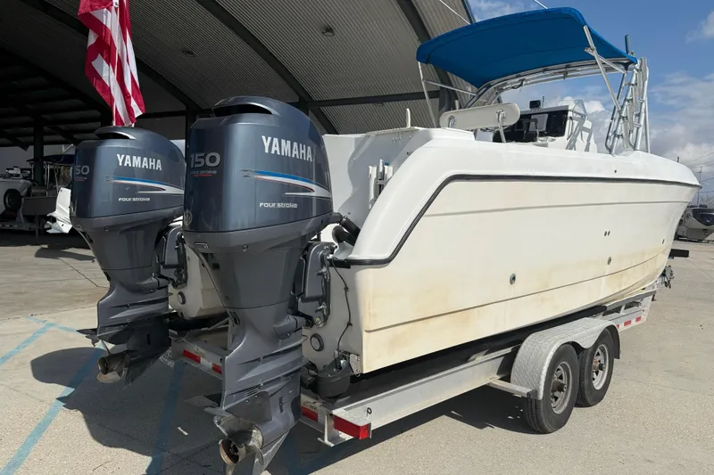 Slide: The Image of 2004 Glacier Bay 260 Canyon Runner with twin Yamaha 150 engines on trailer. - 6