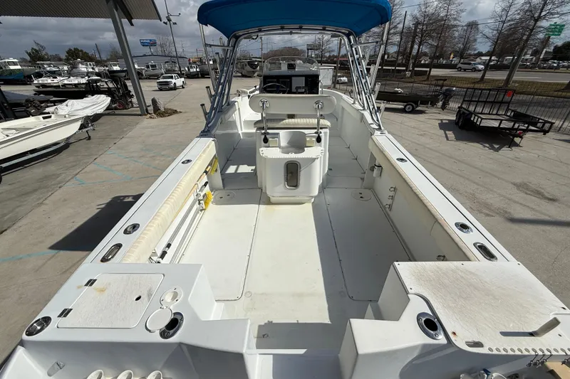 Slide: The Image of 2004 Glacier Bay 260 Canyon Runner boat with spacious deck and blue canopy. - 7