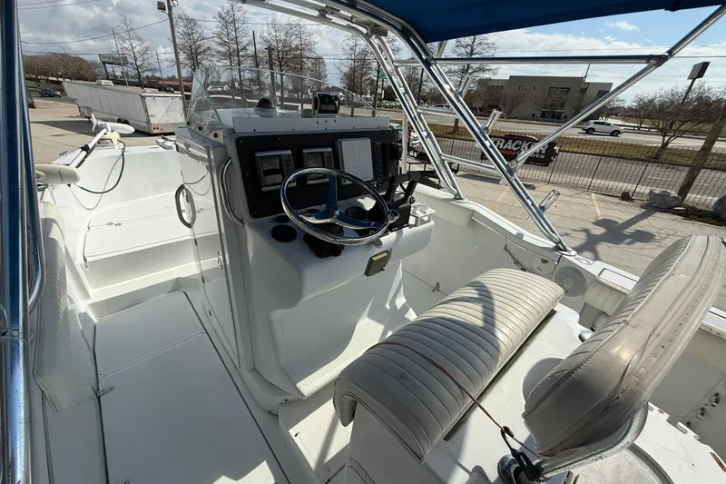 Slide: The Image of 2004 Glacier Bay 260 Canyon Runner boat interior with steering console and seating. - 8