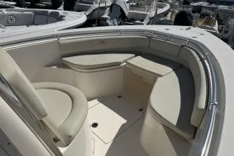 Slide: The Image of 2022 Cobia 237 Center Console boat interior with cushioned seating and storage. - 11