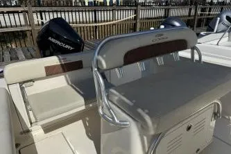 Slide: The Image of 2022 Cobia 237 Center Console boat with Mercury engine, featuring seating and storage. - 13