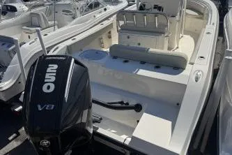 Slide: The Image of 2022 Cobia 237 Center Console boat with powerful outboard motor, docked in marina. - 16