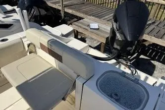 Slide: The Image of 2022 Cobia 237 Center Console boat with seating and engine view. - 6