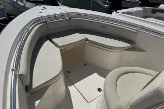 Slide: The Image of 2022 Cobia 237 Center Console boat interior with cushioned seating and storage. - 9