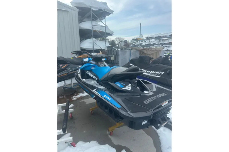 Slide: The Image of 2019 Sea-Doo GTR 230 jet ski in storage, surrounded by snow. - 4