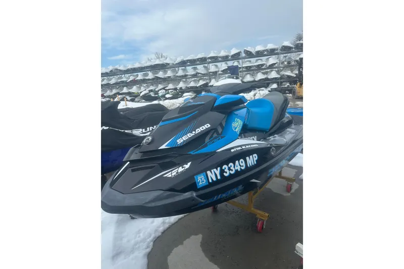 Slide: The Image of 2019 Sea-Doo GTR 230 jet ski in storage, featuring blue and black design. - 5