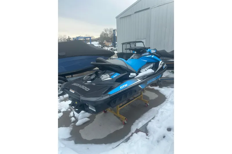 Slide: The Image of 2019 Sea-Doo GTR 230 jet ski in blue and black, parked on snow. - 6
