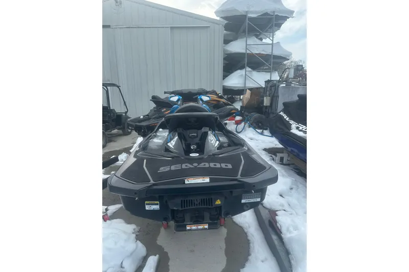 Slide: The Image of 2019 Sea-Doo GTR 230 jet ski parked on snowy ground near storage facility. - 9