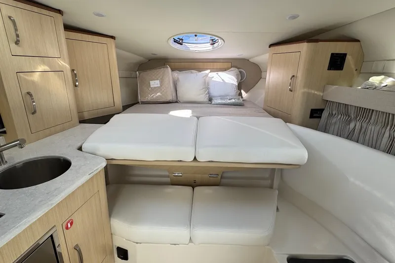 Slide: The Image of Luxurious interior of 2026 Regal 33 XO yacht with cozy bed and modern cabinetry. - 109