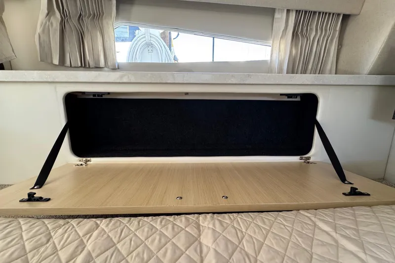 Slide: The Image of Open storage compartment in 2026 Regal 33 XO boat interior. - 117