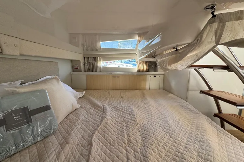 Slide: The Image of Interior cabin of 2026 Regal 33 XO yacht with cozy bed and natural light. - 120