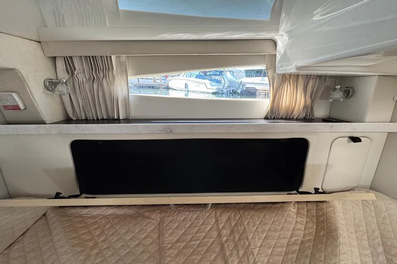 Slide: The Image of Interior cabin view of 2026 Regal 33 XO yacht with window and curtains. - 121