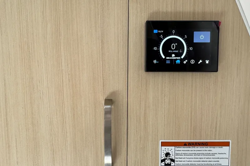 Slide: The Image of Control panel and warning label on 2026 Regal 33 XO boat interior. - 137