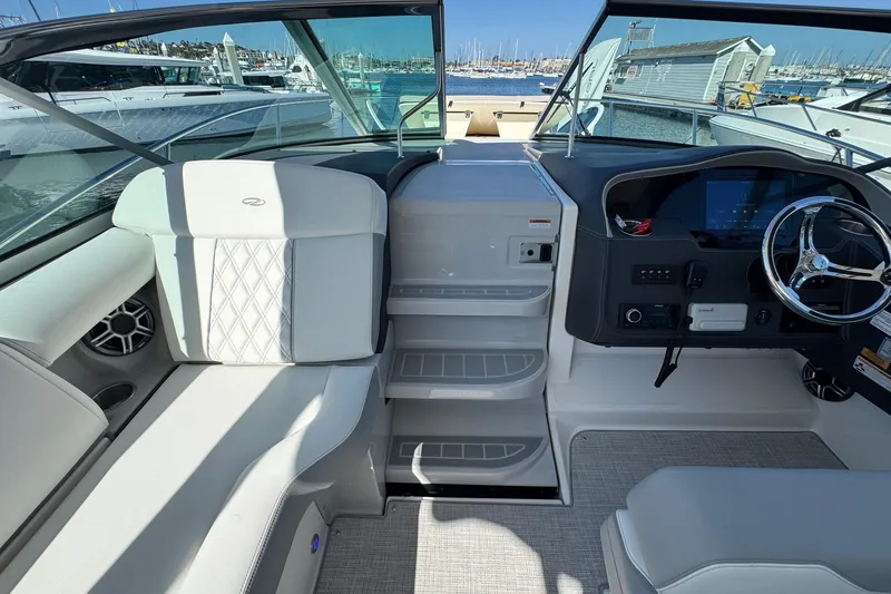 Slide: The Image of 2026 Regal 33 XO boat interior with modern helm and seating at marina. - 49