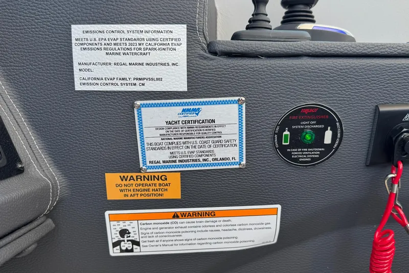 Slide: The Image of Control panel of 2026 Regal 33 XO yacht with safety and certification labels. - 63