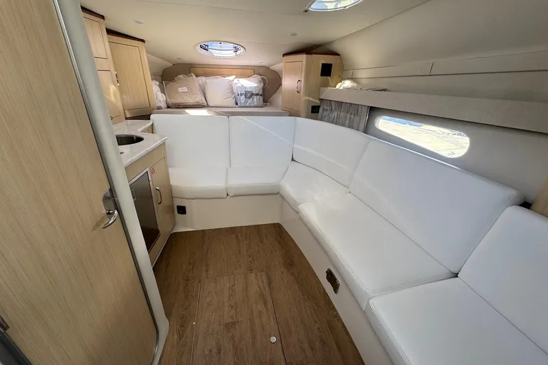 Slide: The Image of Luxurious interior of 2026 Regal 33 XO yacht with white seating and wood accents. - 76