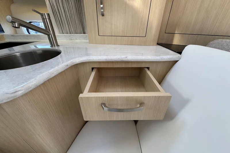 Slide: The Image of 2026 Regal 33 XO yacht interior with open drawer and modern sink. - 85