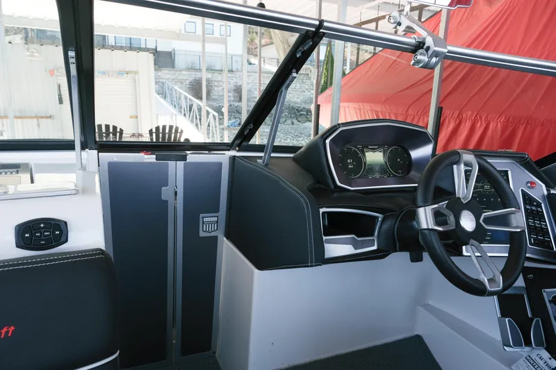 Slide: The Image of Interior of 2020 MasterCraft XT25 boat, featuring modern dashboard and steering wheel. - 16