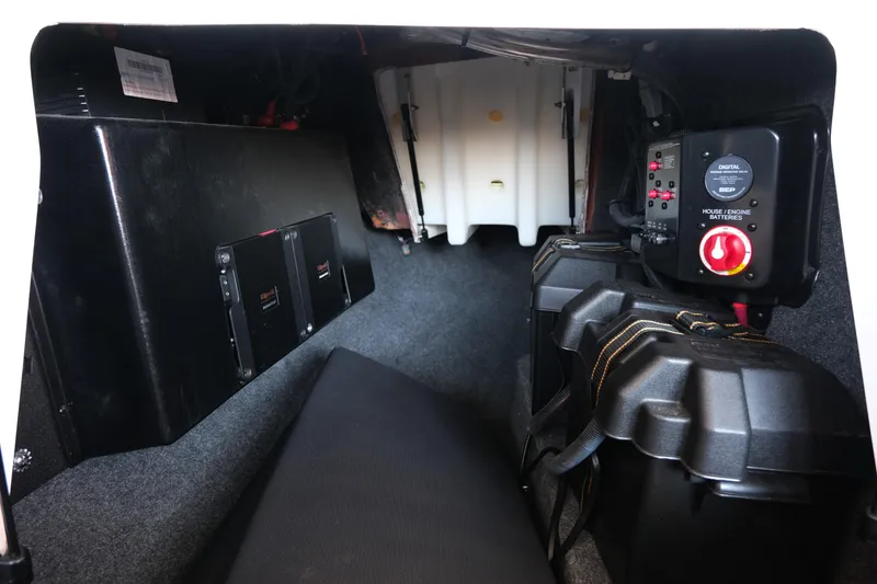 Slide: The Image of 2020 MasterCraft XT25 boat interior showing battery compartment and control panel. - 17