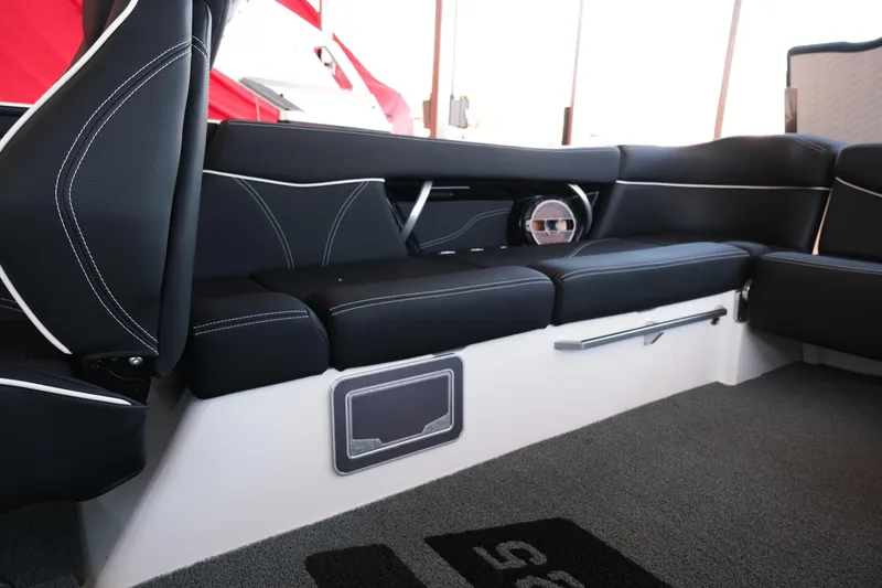 Slide: The Image of 2020 MasterCraft XT25 interior with black seating and speaker detail. - 19
