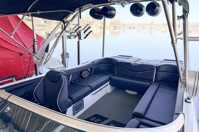 Slide: The Image of 2020 MasterCraft XT25 boat interior with sleek black seating and modern design. - 23