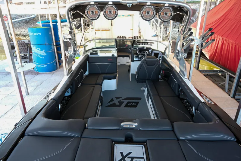 Slide: The Image of 2020 MasterCraft XT25 boat interior with sleek seating and advanced controls. - 4