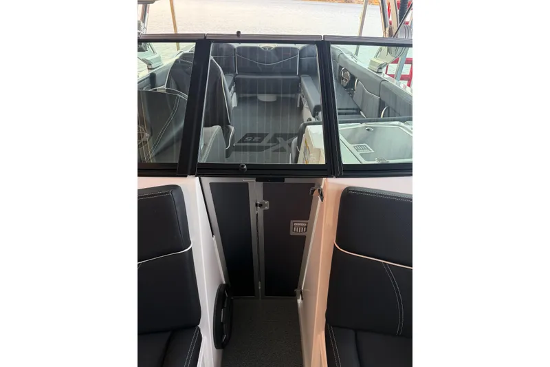 Slide: The Image of Interior view of 2020 MasterCraft XT25 boat with sleek black seating and modern design. - 40