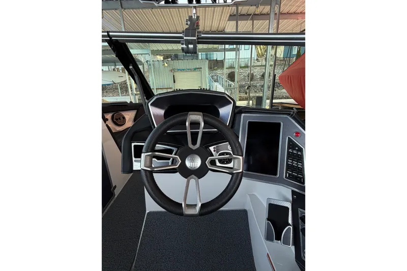 Slide: The Image of 2020 MasterCraft XT25 boat dashboard with steering wheel and control panel. - 42
