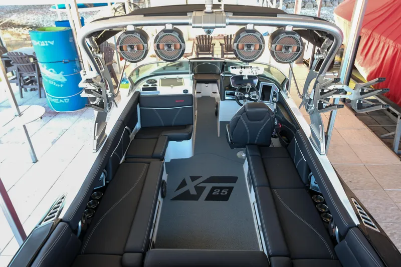 Slide: The Image of 2020 MasterCraft XT25 boat interior with seating and audio system. - 5