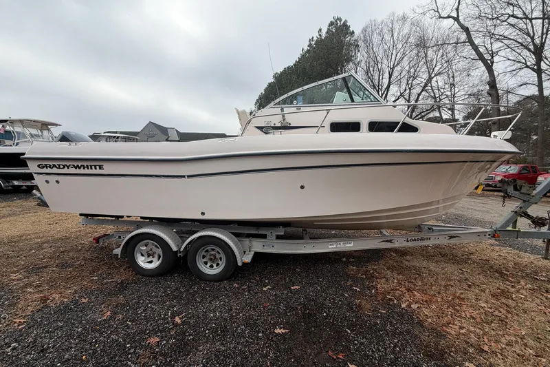 The Image of 2004 Grady-White Gulfstream 232 boat on trailer, parked outdoors. - 0