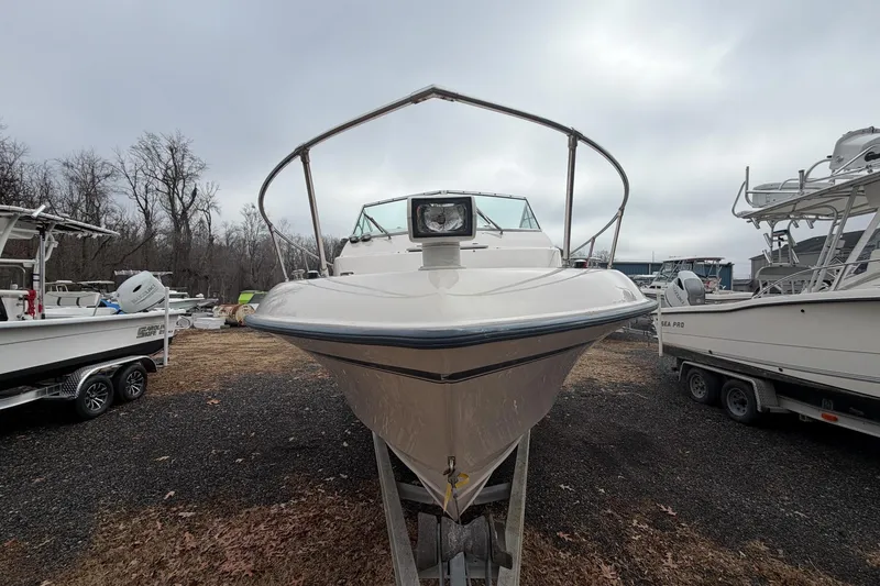 Slide: The Image of 2004 Grady-White Gulfstream 232 boat on trailer, parked outdoors, overcast sky. - 2