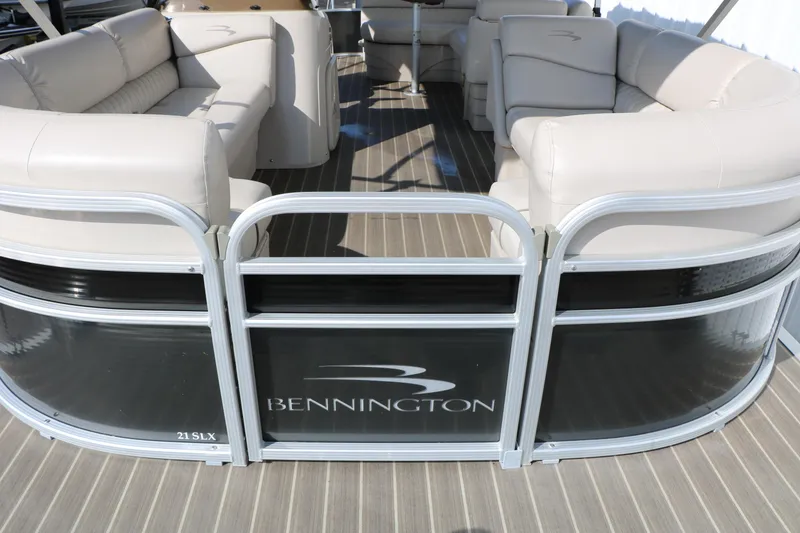 Slide: The Image of 2015 Bennington 21 SLX pontoon boat with beige seating and sleek design. - 21