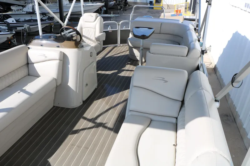 Slide: The Image of 2015 Bennington 21 SLX pontoon boat with spacious seating and modern helm. - 22