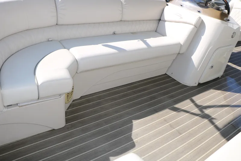 Slide: The Image of 2015 Bennington 21 SLX boat interior with white seating and wood-style flooring. - 25