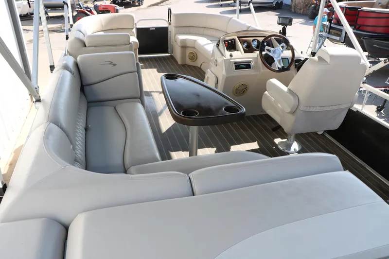 Slide: The Image of 2015 Bennington 21 SLX pontoon boat interior with plush seating and steering console. - 26
