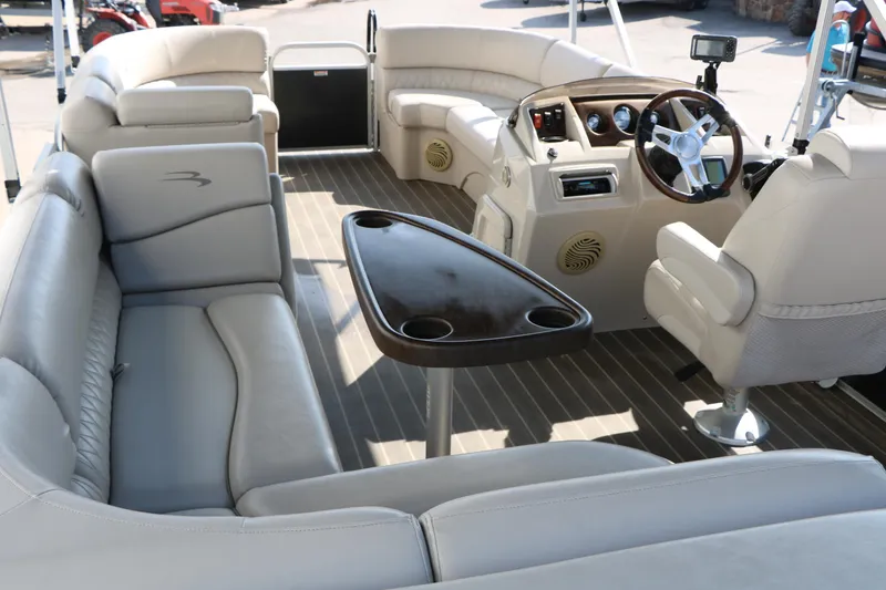 Slide: The Image of 2015 Bennington 21 SLX pontoon boat interior with plush seating and steering console. - 27