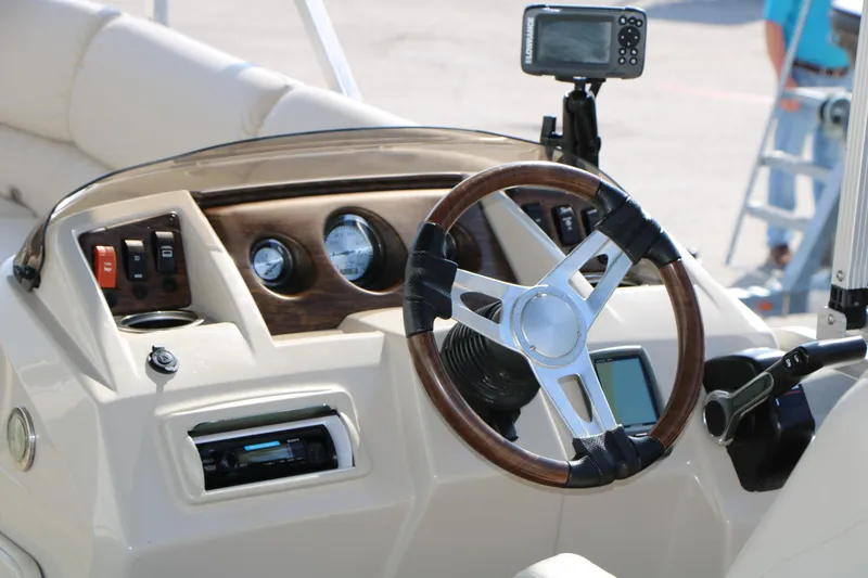 Slide: The Image of 2015 Bennington 21 SLX boat dashboard with steering wheel and navigation system. - 29