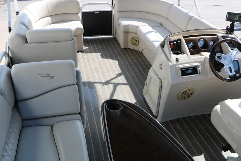 Slide: The Image of 2015 Bennington 21 SLX pontoon boat interior with plush seating and modern dashboard. - 32