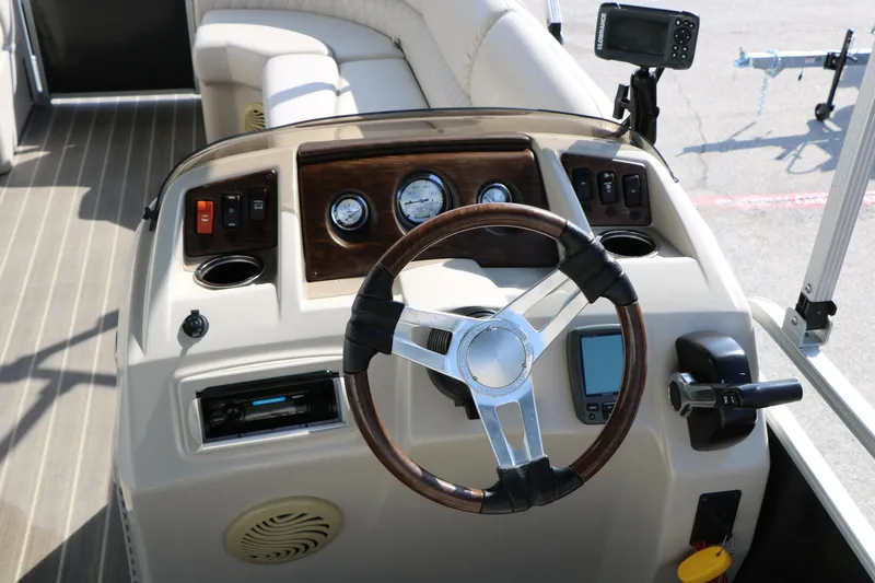 Slide: The Image of 2015 Bennington 21 SLX boat dashboard with steering wheel and control panel. - 33